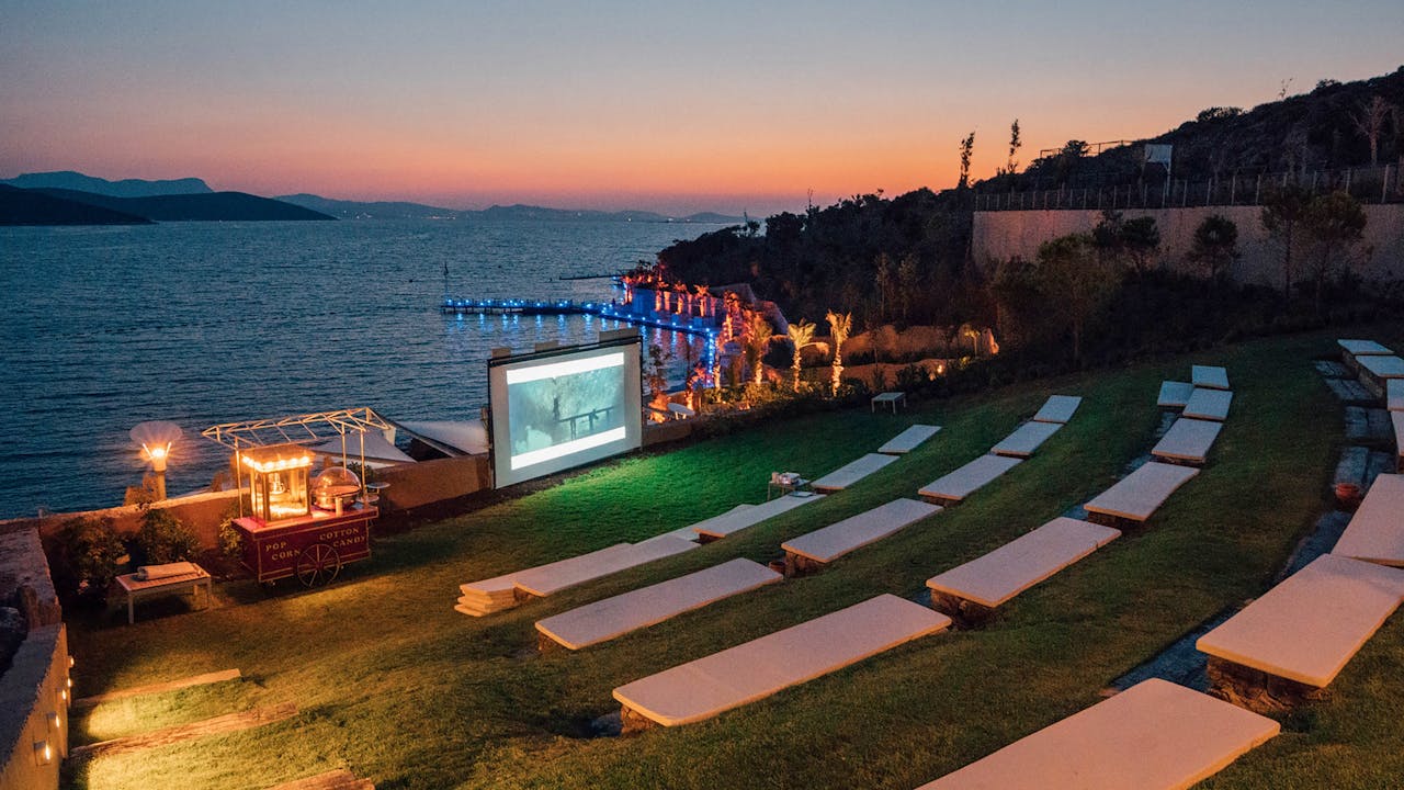 Services Beautiful evening outdoor movie setup by the sea in Bodrum, Turkey.